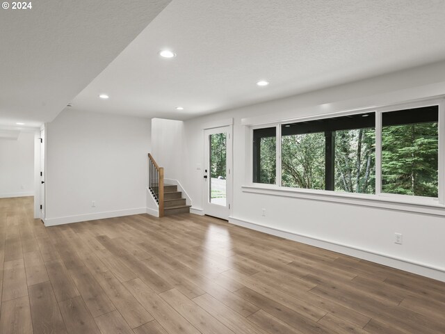 interior space with a textured ceiling and light wood-type flooring