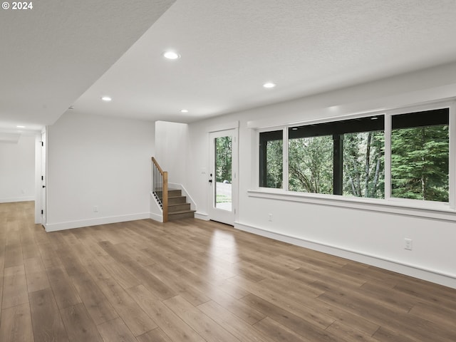 interior space with light hardwood / wood-style flooring and a textured ceiling