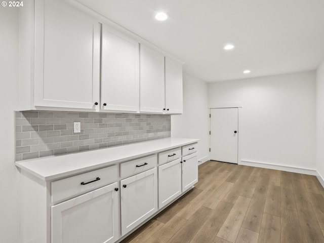 kitchen featuring white cabinetry, tasteful backsplash, and light hardwood / wood-style flooring