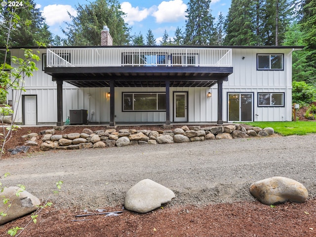 back of property with a deck and central air condition unit