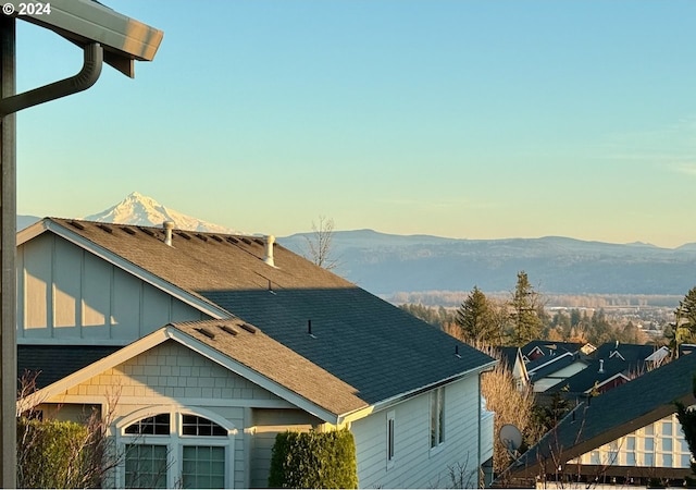 property exterior at dusk with a mountain view