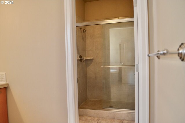 bathroom featuring an enclosed shower and toilet