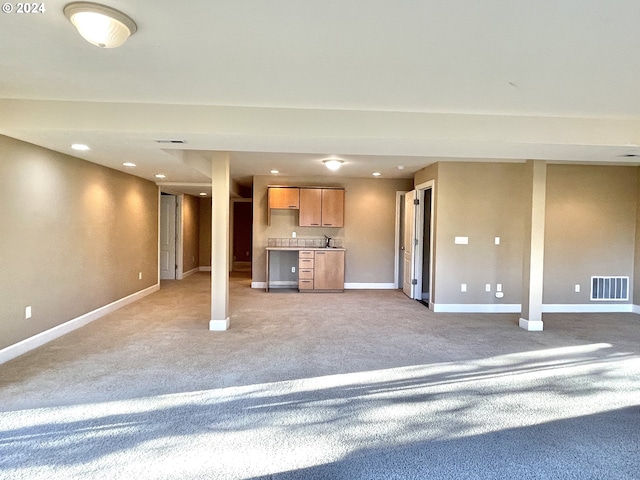 unfurnished living room featuring light colored carpet