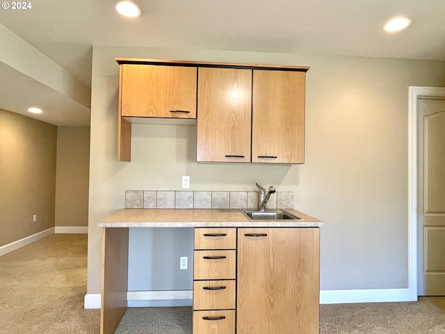 kitchen featuring sink, light colored carpet, and light brown cabinets