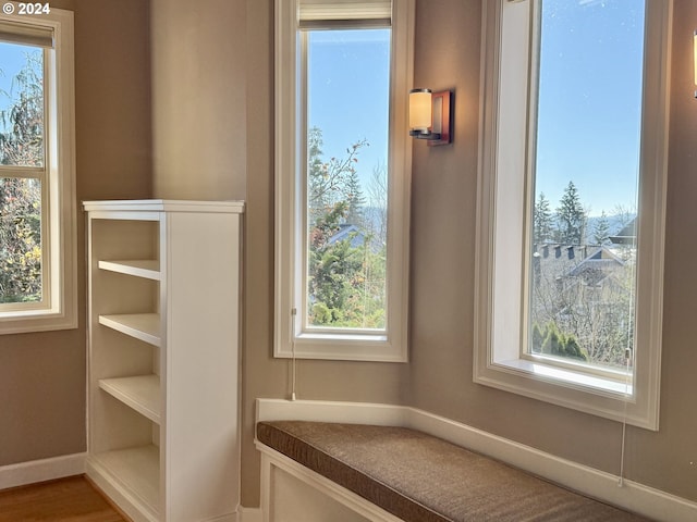 unfurnished living room with lofted ceiling, light hardwood / wood-style floors, and a tile fireplace