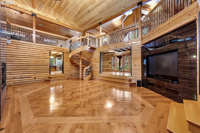 unfurnished living room featuring parquet flooring, a towering ceiling, and wooden ceiling