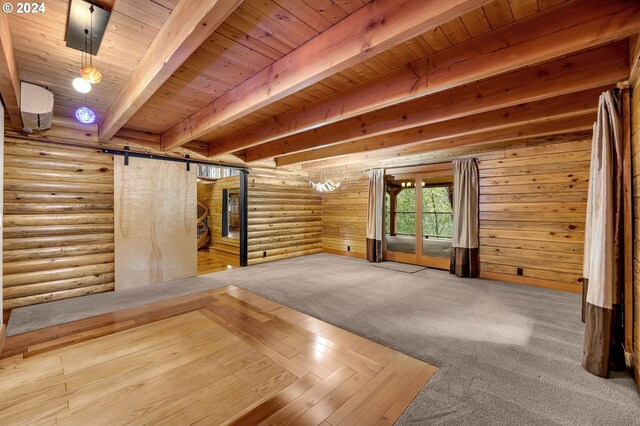 interior space featuring beamed ceiling, a barn door, wooden ceiling, and log walls