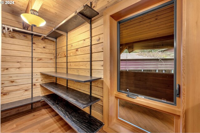 interior space featuring wooden walls, hardwood / wood-style floors, and wooden ceiling