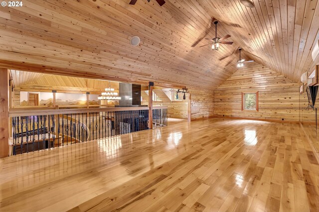 bonus room with wood walls, ceiling fan, hardwood / wood-style floors, wood ceiling, and lofted ceiling