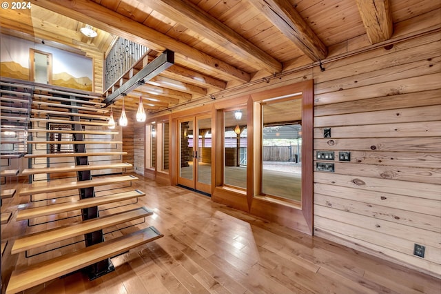 hallway featuring beamed ceiling, french doors, wood ceiling, hardwood / wood-style flooring, and wood walls