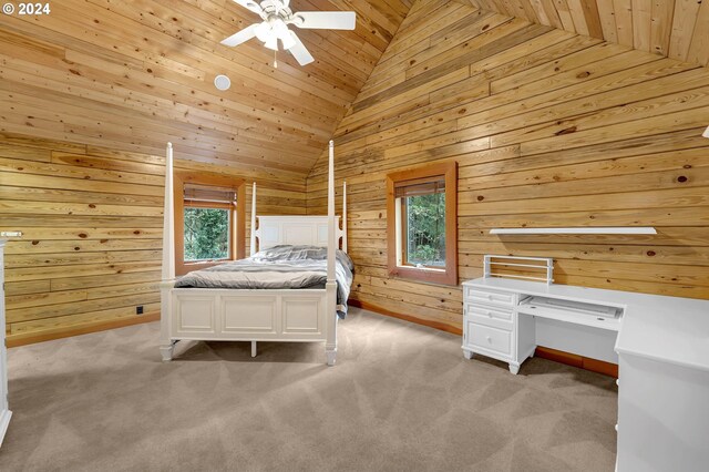 carpeted bedroom featuring multiple windows, ceiling fan, wood walls, and wooden ceiling