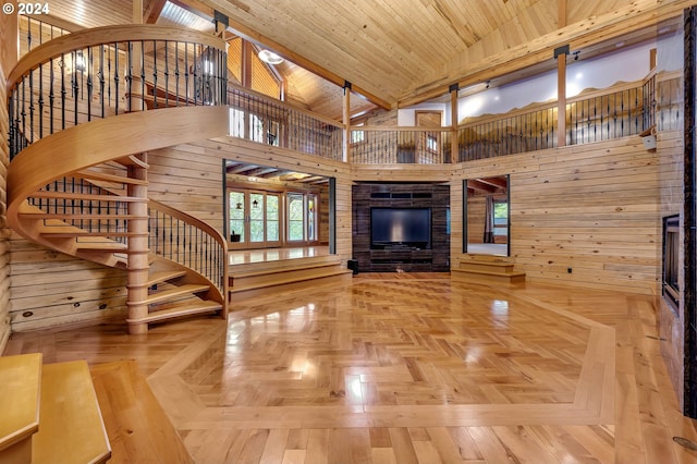 unfurnished living room featuring high vaulted ceiling, wood walls, and wooden ceiling