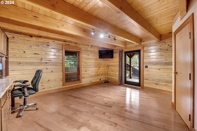 unfurnished office with wooden walls, beam ceiling, wood ceiling, and light hardwood / wood-style flooring