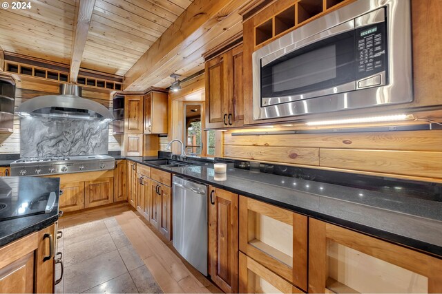 kitchen with beamed ceiling, sink, light hardwood / wood-style flooring, stainless steel appliances, and wooden ceiling