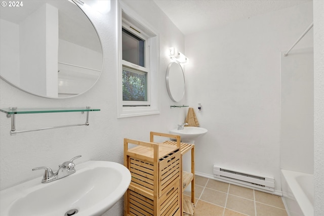 bathroom featuring sink, washtub / shower combination, tile patterned floors, and a baseboard heating unit