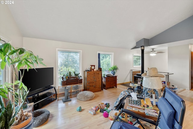 living room with lofted ceiling, light hardwood / wood-style floors, and ceiling fan