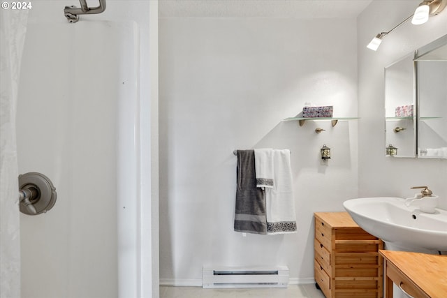 bathroom featuring baseboard heating, vanity, and tile patterned flooring