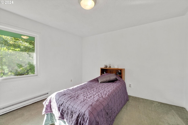 bedroom with carpet and baseboard heating