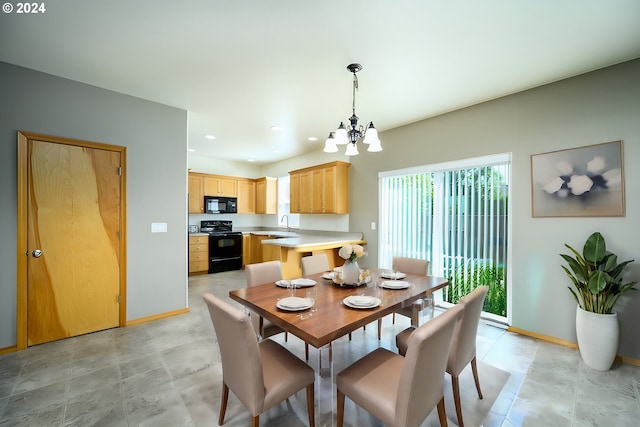 dining room featuring sink and an inviting chandelier