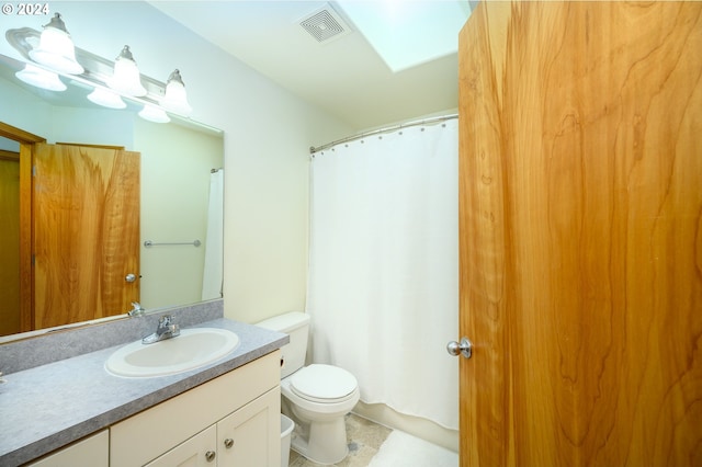 bathroom featuring toilet and vanity