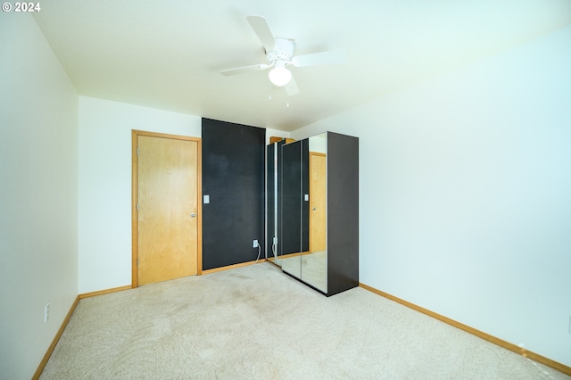 unfurnished bedroom with carpet flooring, a closet, and ceiling fan