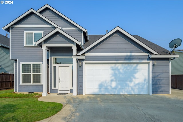 craftsman-style house featuring a front yard and a garage