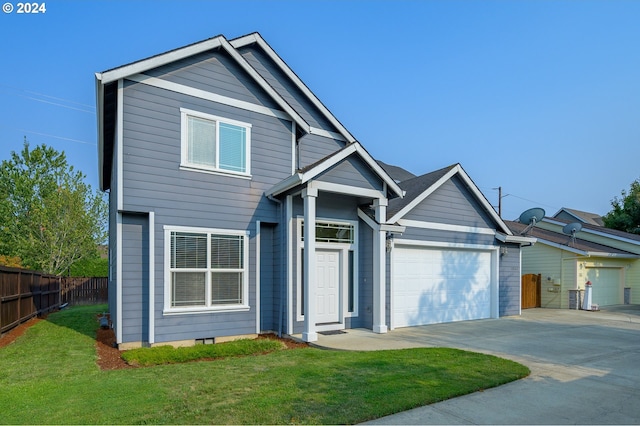 view of front of house with a front yard and a garage