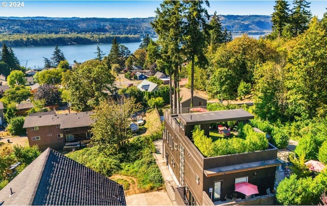 aerial view featuring a water and mountain view and a wooded view