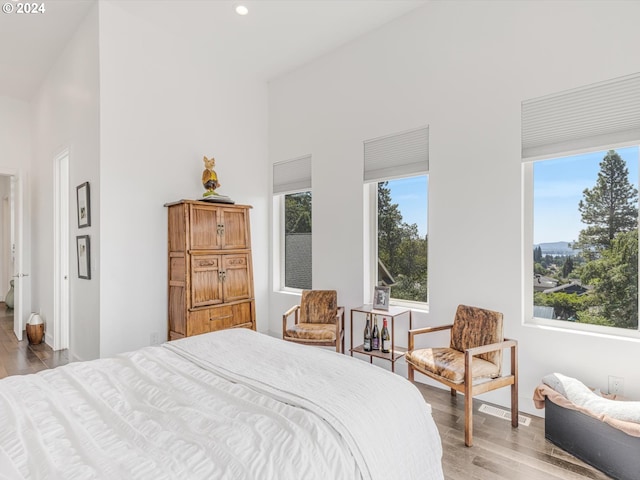 bedroom featuring recessed lighting, multiple windows, light wood-type flooring, and visible vents