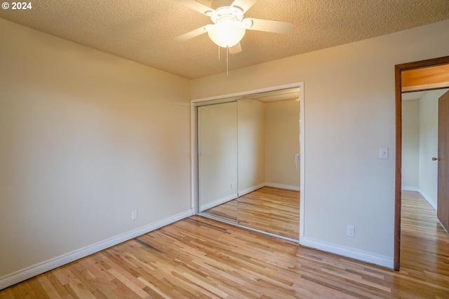 unfurnished bedroom featuring a closet, ceiling fan, a textured ceiling, and light hardwood / wood-style flooring