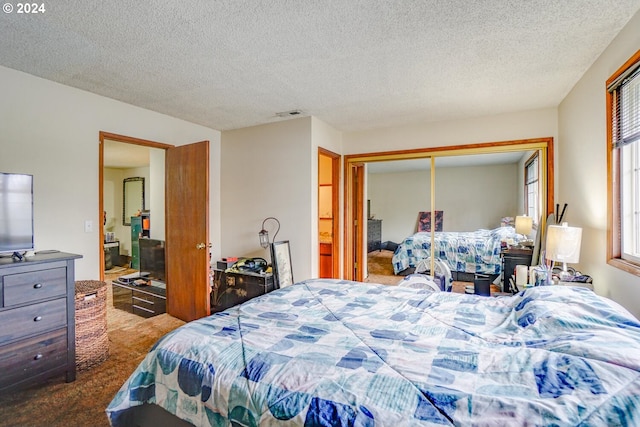 bedroom featuring carpet flooring, a closet, and a textured ceiling