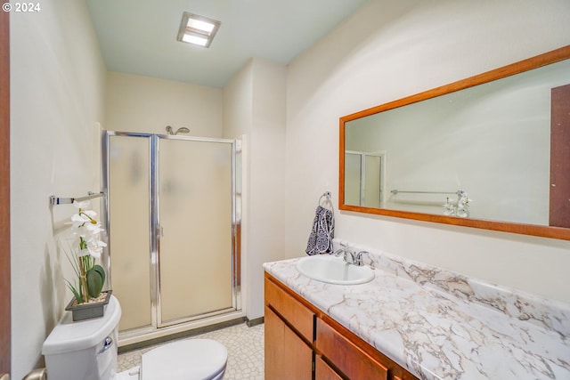 bathroom with toilet, walk in shower, and vanity