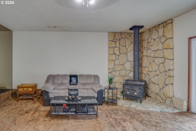 carpeted living room with a textured ceiling and a wood stove