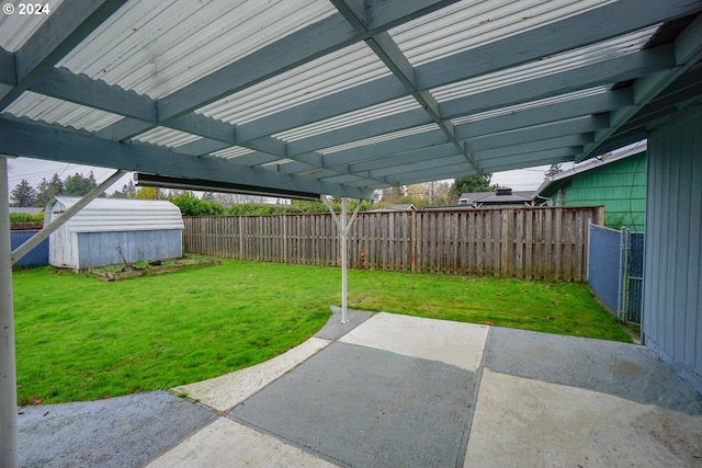 view of yard featuring a patio and a shed