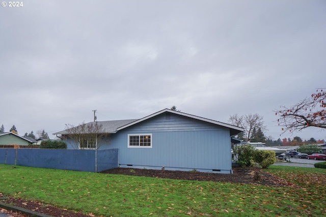 view of property exterior with a lawn