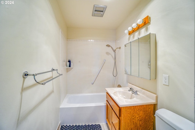 full bathroom with toilet, vanity, and tiled shower / bath