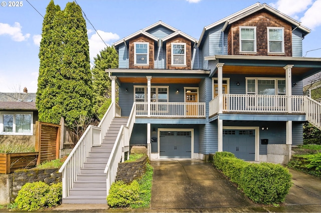 view of front of house featuring concrete driveway, stairs, a porch, and an attached garage