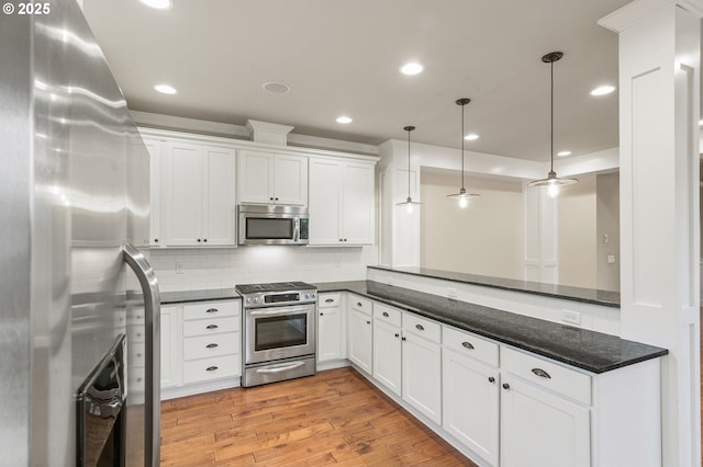 kitchen featuring white cabinetry, tasteful backsplash, light wood finished floors, and stainless steel appliances