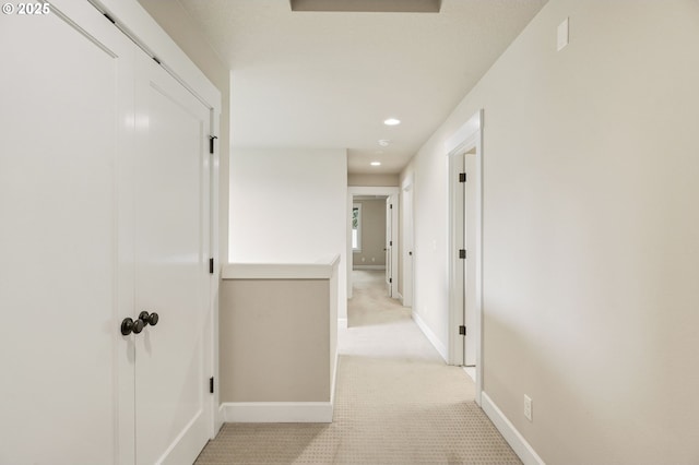 hall featuring light carpet, recessed lighting, and baseboards
