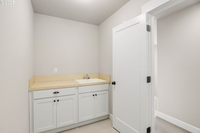 bathroom with vanity and baseboards