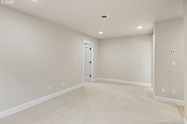 unfurnished room featuring visible vents, baseboards, recessed lighting, and light carpet