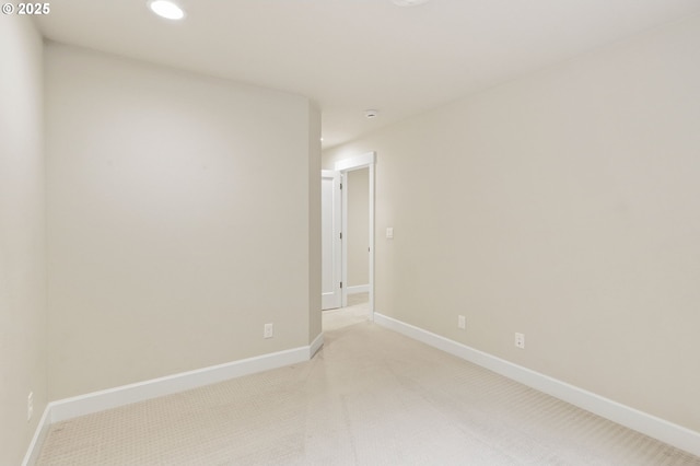 unfurnished room featuring recessed lighting, light colored carpet, and baseboards