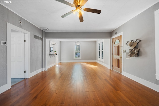 unfurnished living room with a ceiling fan, baseboards, visible vents, and hardwood / wood-style floors