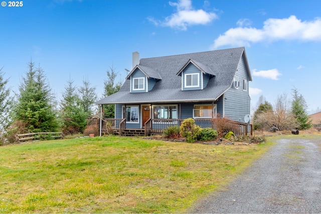 cape cod-style house featuring covered porch and a front lawn