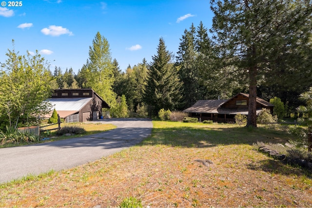 96 Mount Adams Rd, Trout Lake, WA 98650 - view of grassy yard featuring asphalt driveway and a forest view