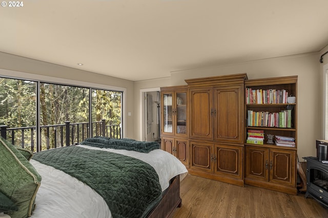 bedroom with hardwood / wood-style flooring and access to exterior