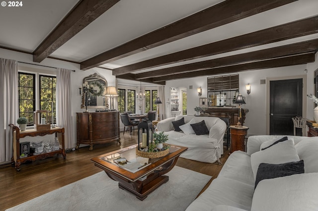 living room with a wealth of natural light, dark wood-type flooring, and beam ceiling