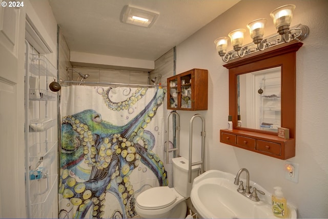 bathroom featuring a sink, toilet, and a shower with shower curtain