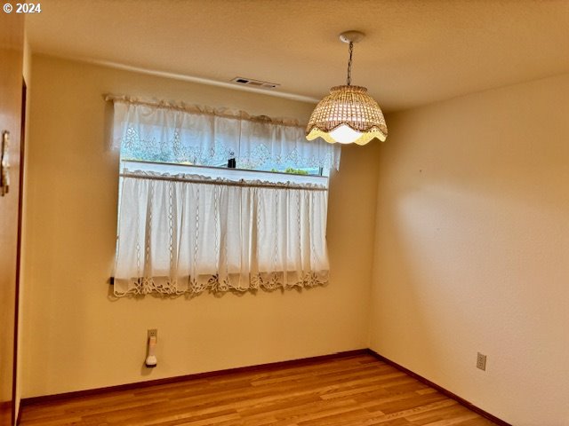 empty room featuring hardwood / wood-style flooring