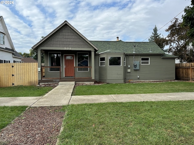 bungalow-style house featuring a front yard